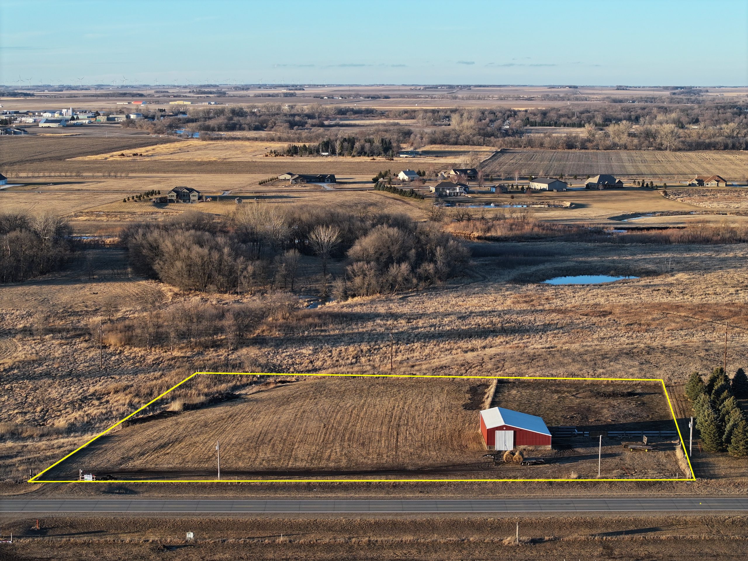 Aerial view of rural land for sale, including a barn.