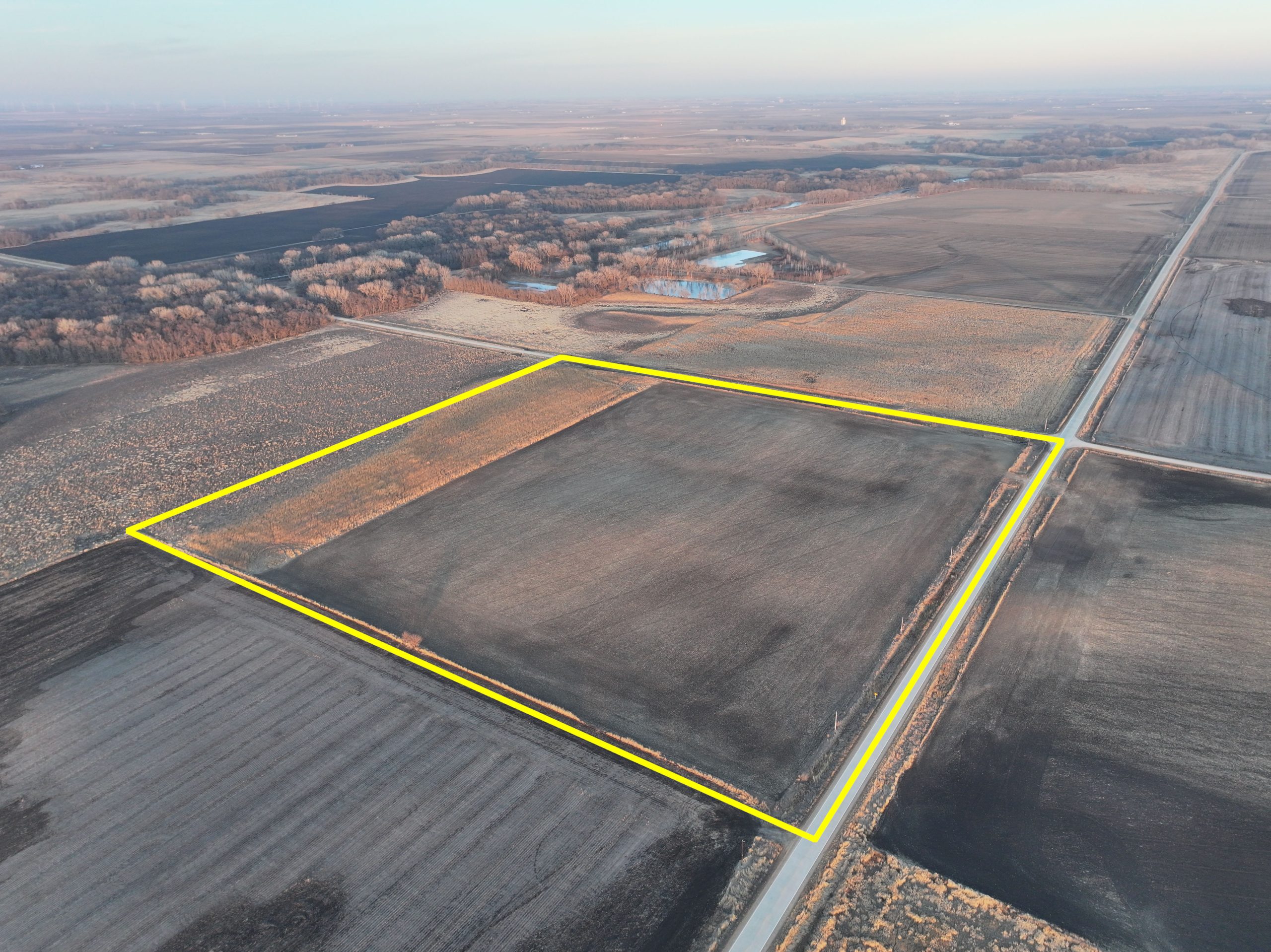 Aerial view of a square parcel of farmland bordered by roads.