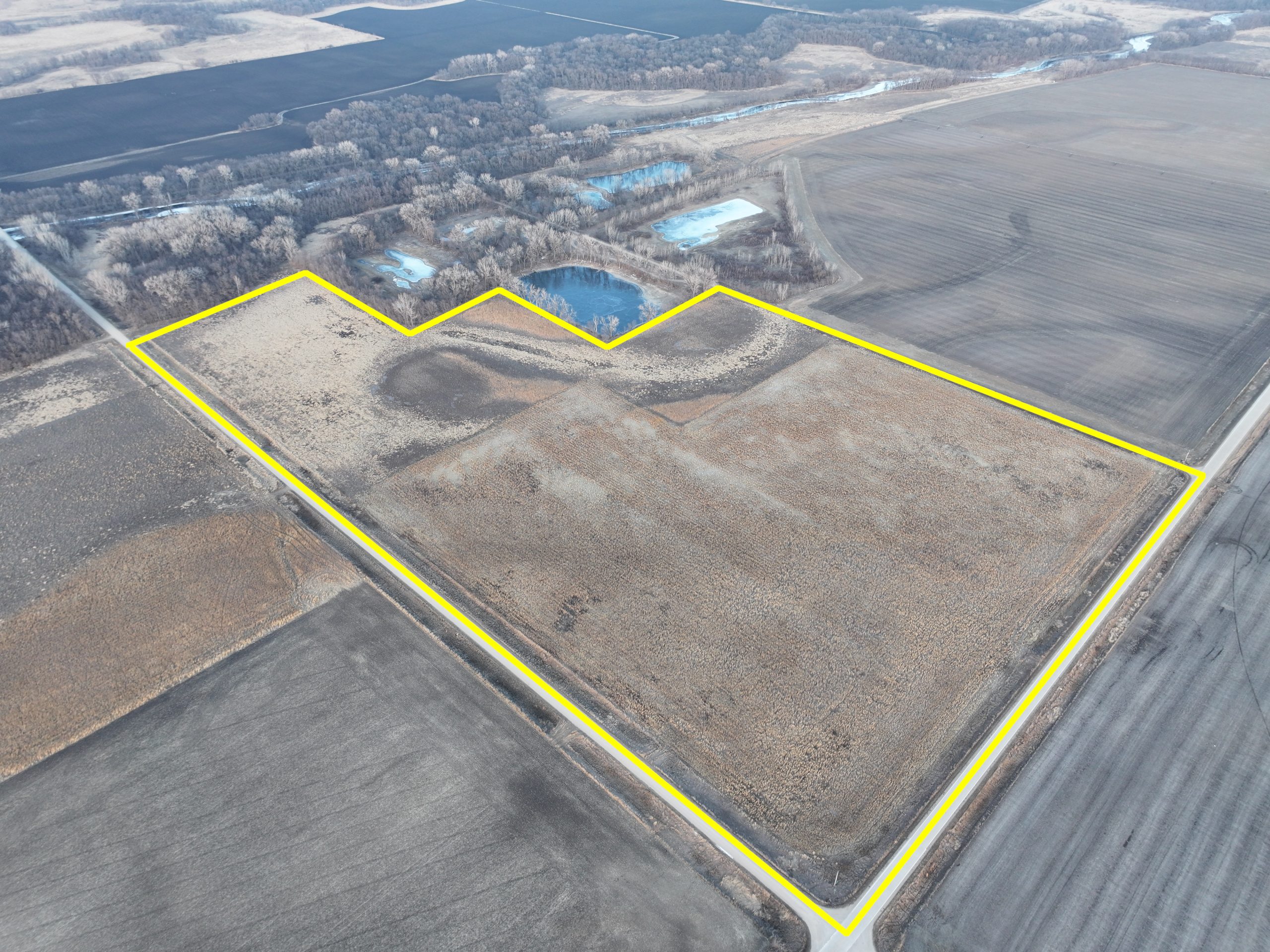 Aerial view of a rural property outlined in yellow.