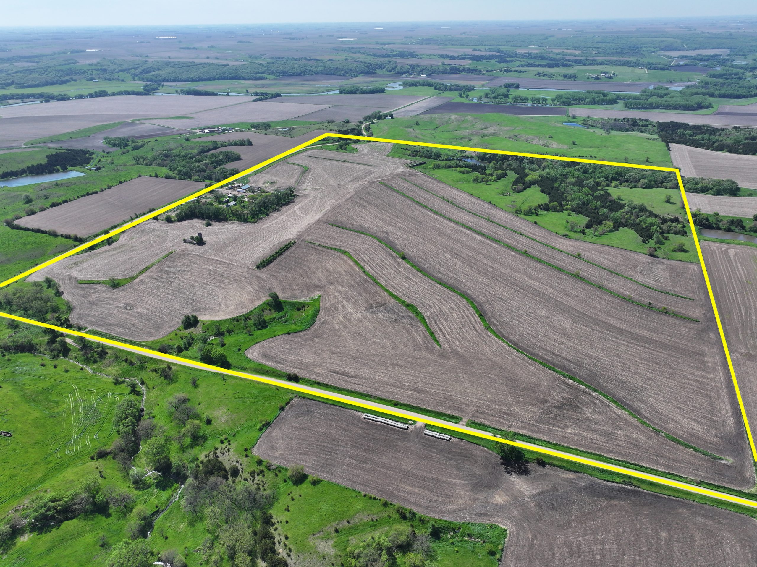 Aerial view of a large, irregularly shaped farm outlined in yellow.