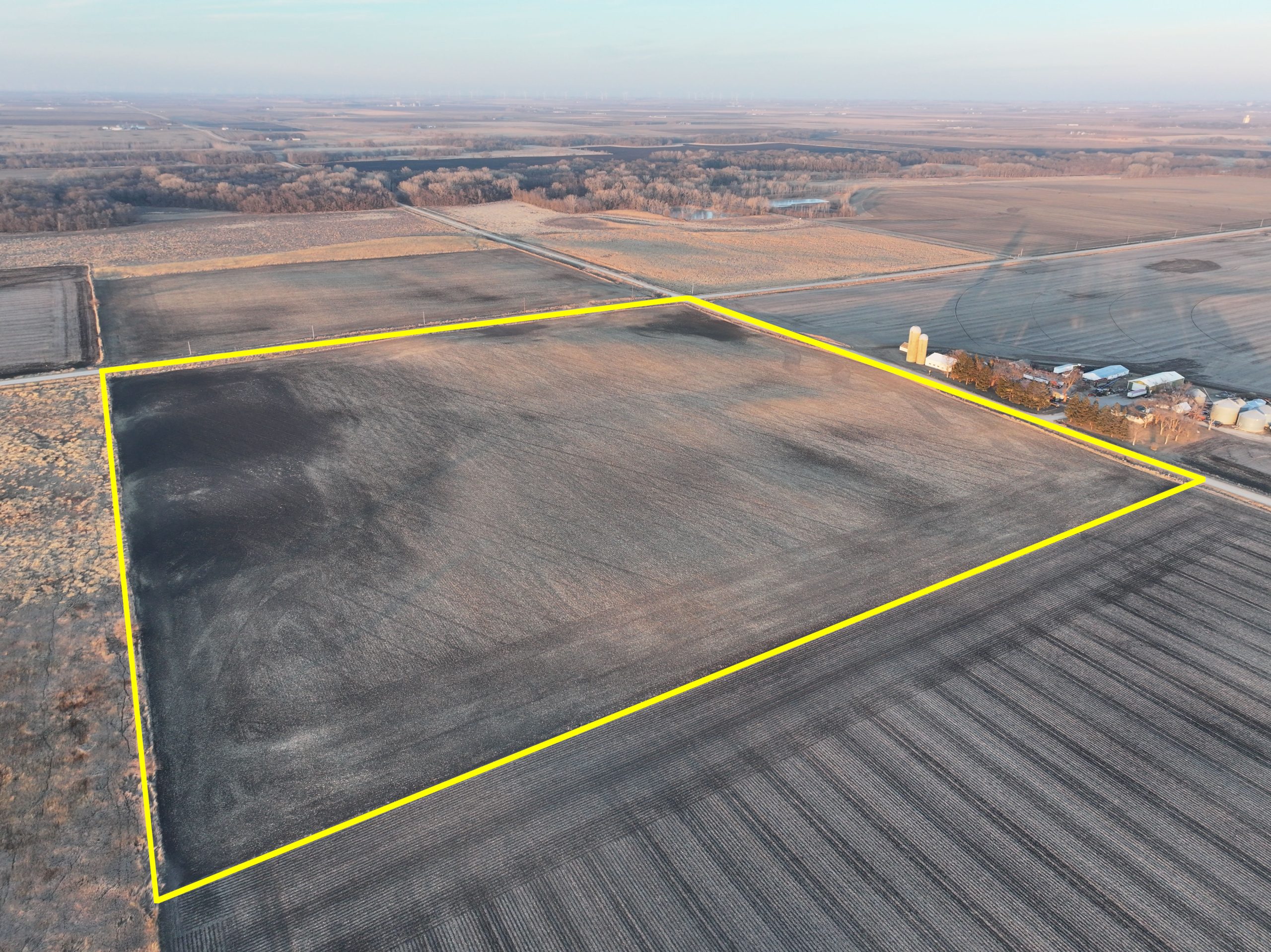 Aerial view of a large, square farmland plot outlined in yellow.