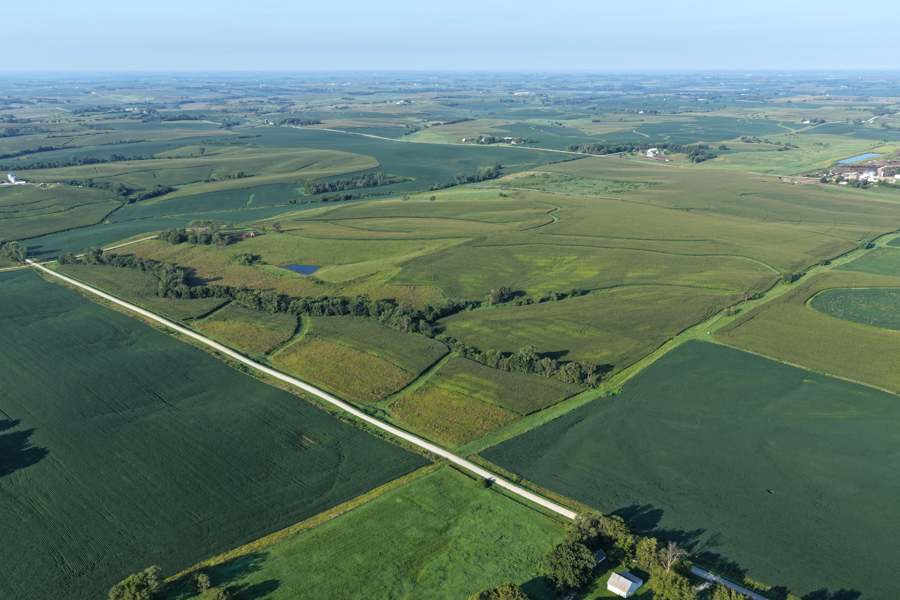 Aerial view of Iowa farmland crossed by a gravel road